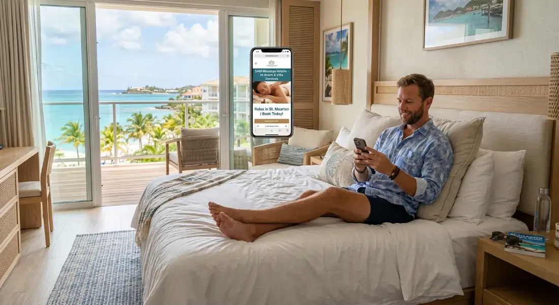 Hotel guest booking a mobile massage on his phone in a St. Maarten beachfront room